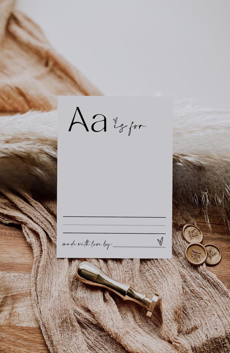 May include: A printable card with the letter "A" and the text "A is for" followed by a blank line for writing. The card also has the text "made with love by:" followed by a blank line for writing. The card is on a brown surface with a gold wax seal.