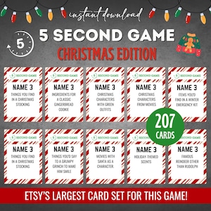 May include: A set of 207 Christmas-themed cards for the 5 Second Game. The cards feature red and white striped backgrounds with green text. The cards have different prompts for the game, such as "Name 3 things you find in a Christmas stocking" and "Name 3 famous reindeer other than Rudolph".