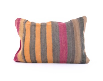 May include: A striped throw pillow with a variety of colors, including orange, brown, gray, and pink.