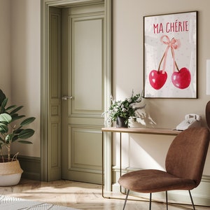 May include: A watercolor print with two red cherries and a pink ribbon. The print has the text "MA CH&Eacute;RIE" in black lettering.