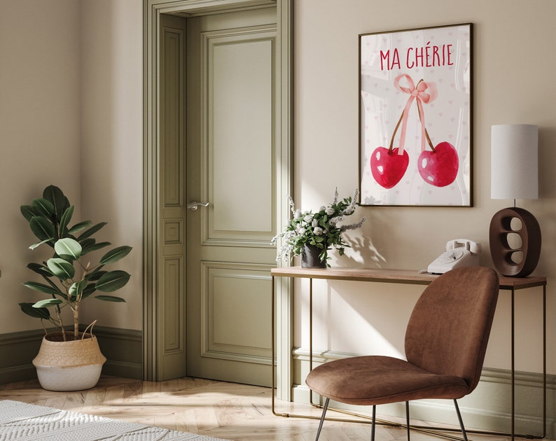 May include: A watercolor print with two red cherries and a pink ribbon. The print has the text "MA CH&Eacute;RIE" in black lettering.