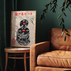 May include: A framed print with a black and white illustration of a stack of vinyl records with chopsticks holding a record in the air. The text "酒げるビート" is printed in red at the top of the print.