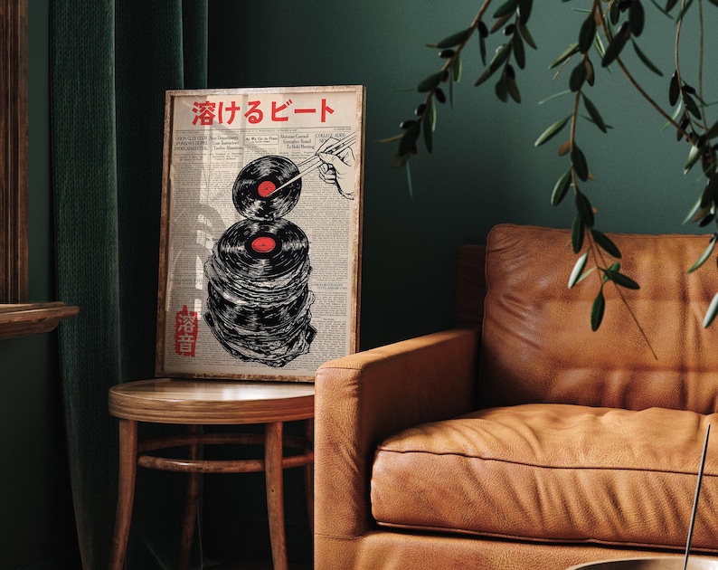 May include: A framed print with a black and white illustration of a stack of vinyl records with chopsticks holding a record in the air. The text "酒げるビート" is printed in red at the top of the print.