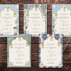 Könnte beinhalten: Fünf Hochzeitseinladungskarten mit goldenen Laternen- und Blumendesigns. Jede Karte zeigt die Namen "Varun Anjali" und Veranstaltungsdetails. Die Karten sind vor einem Holzgrund, mit einem Federakzent.