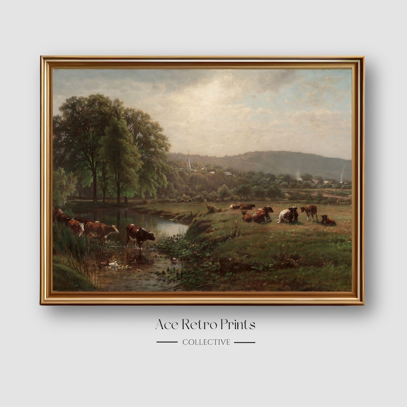 May include: A vintage painting depicting a pastoral scene with a stream running through a grassy field.  The painting features a group of brown and white cows grazing in the field.  The sky is a light blue with white clouds.  The painting is framed in a gold frame.