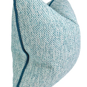 May include: A blue and white patterned throw pillow with a dark blue trim.
