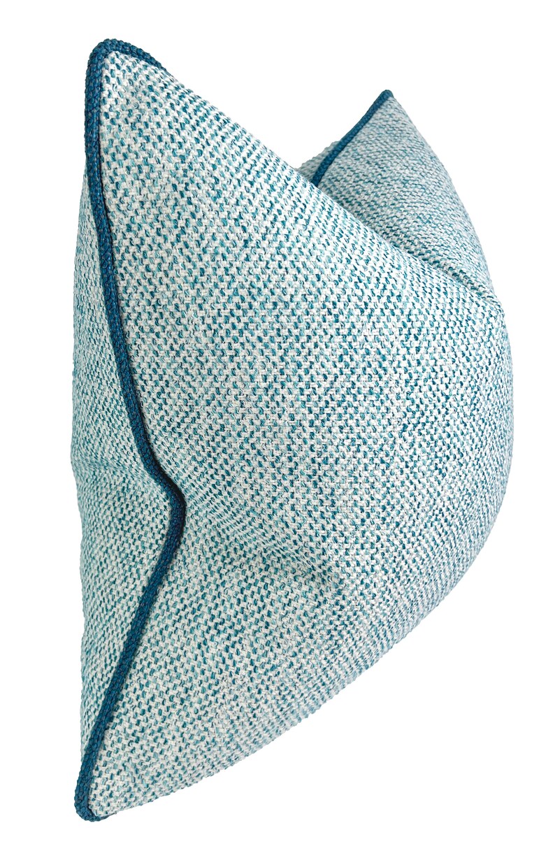 May include: A blue and white patterned throw pillow with a dark blue trim.