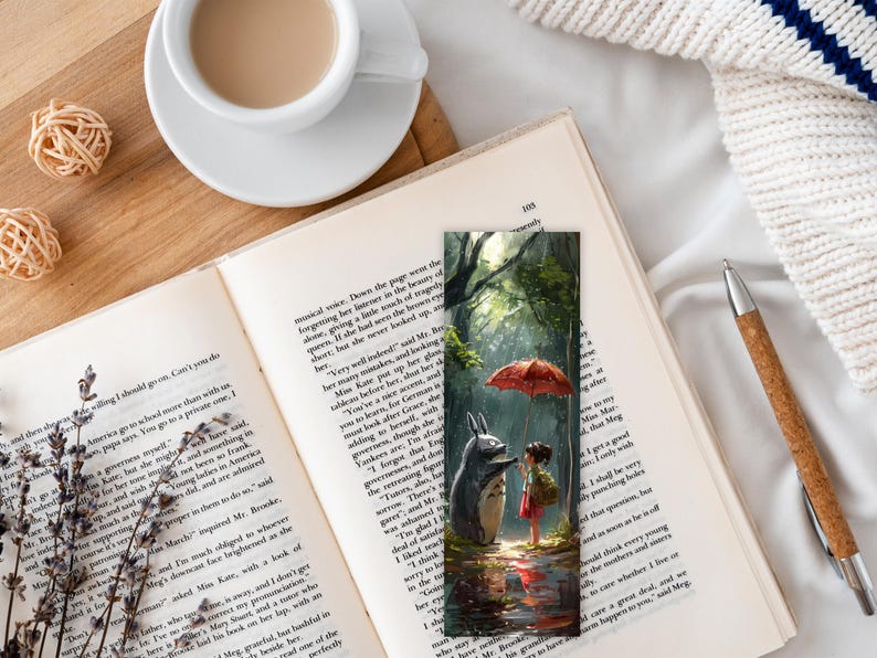 May include: A bookmark featuring a whimsical illustration of a furry, gray creature with large ears and a red umbrella. The creature is standing in a forest setting with green trees and a path. The illustration is painted in a realistic style with soft colors.