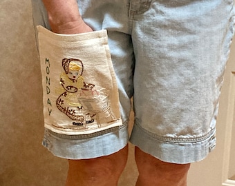 Repurposed vintage embroidered Monday chore towel as a pocket on denim shorts / reworked 40s 50s upcycled linens day of the week shorts