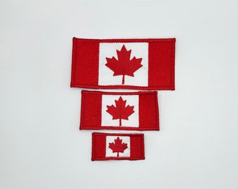 May include: Three Canadian flag patches in different sizes. The patches are red with a white center and a red maple leaf.