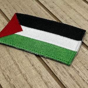 May include: A green, white, black, and red embroidered patch with the Palestinian flag.