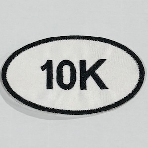 May include: White oval patch with a black border and the text "10K" in black.