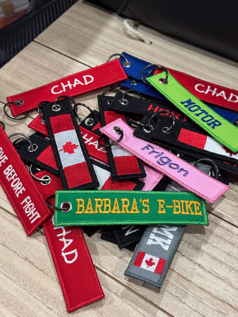 A collection a different custom embroidered keytags