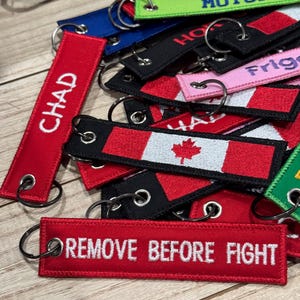 A collection a different custom embroidered keytags
