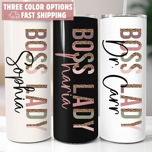 May include: Three insulated tumblers with the words "BOSS LADY" in a leopard print design. One tumbler is white with the name "Sophia", another is black with the name "Maria", and the third is white with the name "Dr. Carr".