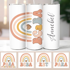 May include: Three white tumblers with a rainbow design and different text on each. The first tumbler has a rainbow with a heart and the text "PARA PROFESSIONAL". The second tumbler has a rainbow with a heart and the text "BCBA". The third tumbler has a rainbow with a heart and the text "RBT".