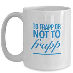 May include: White ceramic coffee mug with a blue inscription that reads "To Frapp or Not To Frapp" with a line underneath the text.