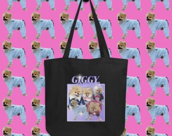 Könnte beinhalten: Schwarze Tragetasche mit einer weißen Grafik von vier Zwergspitzen, die Outfits tragen, und dem Text "GIGGY dress shop" auf einem lila Hintergrund.