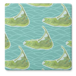 May include: Square coaster with a repeating pattern of a green and white landmass on a teal background with wavy lines. The landmass has a curved shape with a pointed end and a white area along the top.