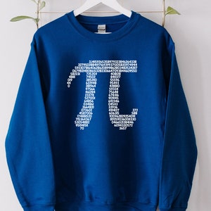May include: A royal blue sweatshirt featuring a white graphic of the mathematical constant pi, formed by the digits of pi.