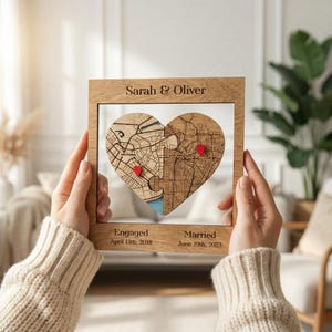 May include: Wooden heart-shaped map puzzle in a wooden frame, featuring city maps and red heart markers. The frame is inscribed with "Sarah & Oliver", and the dates "April 13th, 2018" and "June 19th, 2023".