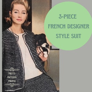 May include: A three-piece French designer style suit in black and white with a geometric pattern. The suit includes a jacket, skirt, and top. The model is holding a small black and white dog.