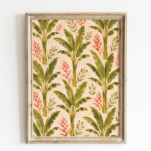 Könnte beinhalten: Ein gerahmter Kunstdruck mit einem sich wiederholenden Muster aus grünen Bananenstauden und rosa tropischen Blumen auf hellbeigem Hintergrund. Der rechteckige Rahmen besteht aus hellem Holz mit sichtbarer Maserung und schlichtem Profil.