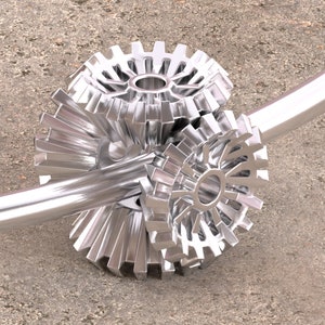 May include: A silver metal gear set with multiple interlocking gears. The gears are connected by a silver metal rod.