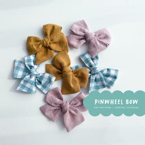 May include: An assortment of handmade pinwheel bows in various colors, including mustard yellow, dusty rose, and blue and white gingham. The bows are arranged on a white surface. The image also includes text that reads "PINWHEEL BOW PDF PATTERN + SEWING TUTORIAL."