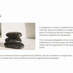 May include: A stack of three smooth, dark grey stones on a white surface. The stones are stacked in a pyramid shape, with the largest stone at the bottom and the smallest stone at the top. The stones are smooth and have a natural, organic look.