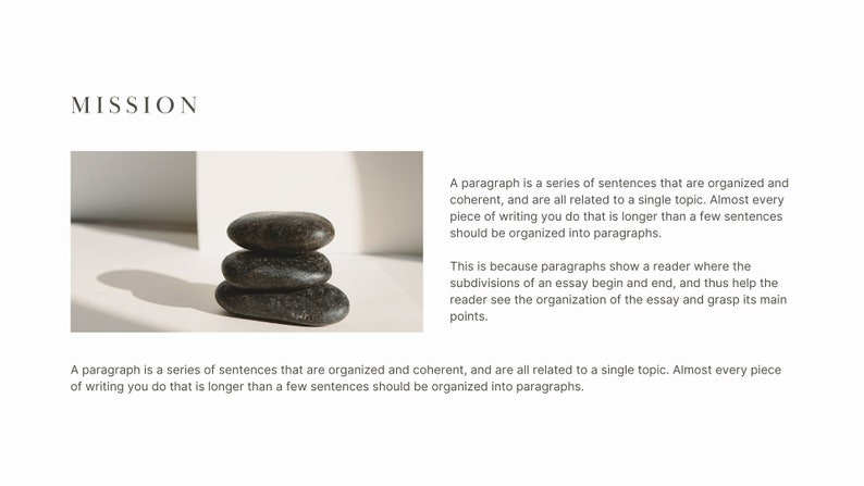 May include: A stack of three smooth, dark grey stones on a white surface. The stones are stacked in a pyramid shape, with the largest stone at the bottom and the smallest stone at the top. The stones are smooth and have a natural, organic look.