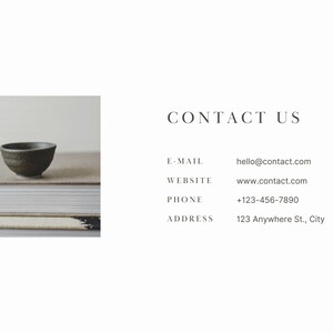 May include: A small, dark green ceramic bowl sits on top of a stack of books. The bowl is slightly tilted to the side. The books are stacked on a light brown surface. The text "CONTACT US" is displayed in a white font on a white background. Below the text, contact information is listed: "E-MAIL: hello@contact.com", "WEBSITE: www.contact.com", "PHONE: +123-456-7890", and "ADDRESS: 123 Anywhere St., City".