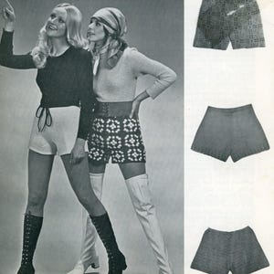May include: A vintage black and white photograph featuring two women modeling crochet shorts and thigh-high boots. The shorts are in various styles, including a patterned design. The women are wearing long-sleeved tops and belts, showcasing 1970s fashion.
