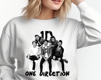 May include: White sweatshirt with a black and white photo of a boy band, the text "1D" and "ONE DIRECTION" printed on the front.