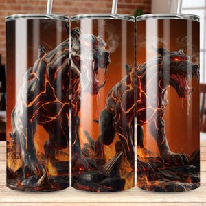 May include: Three stainless steel tumblers with a black and orange lava monster design. The monster is snarling with its mouth open and has glowing red eyes.