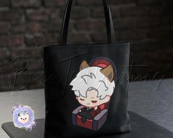 May include: Black tote bag with a cartoon character with white hair, brown ears, and a red and black outfit, seated in a red chair. The bag has black handles and is on a black surface. The text "Bobo Creations" is visible.