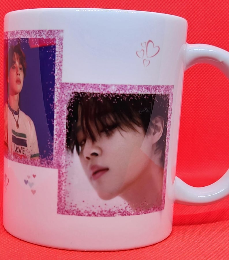 May include: White ceramic mug with a pink glitter border around two images of a man with black hair. The mug has a pink handle and the text "LOVE" is visible on the man's shirt in the left image.