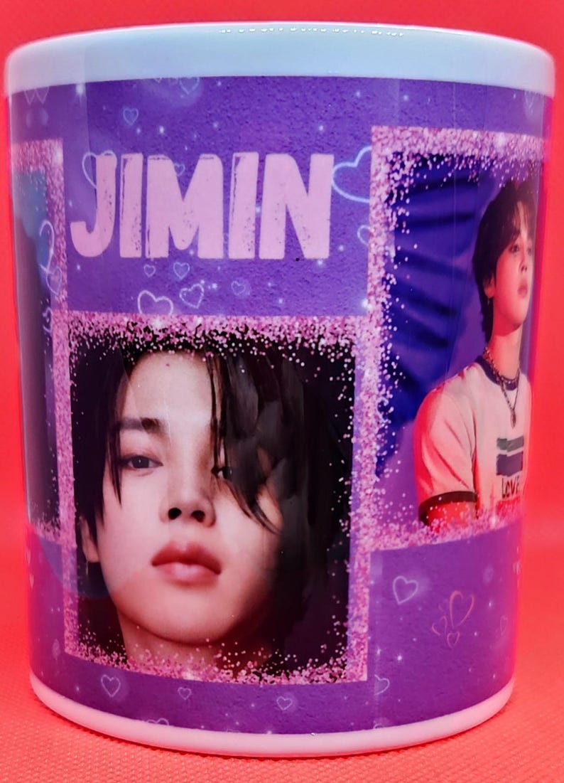 May include: A purple ceramic mug with a glittery design featuring a photo of a person with the name "Jimin" printed in pink letters.