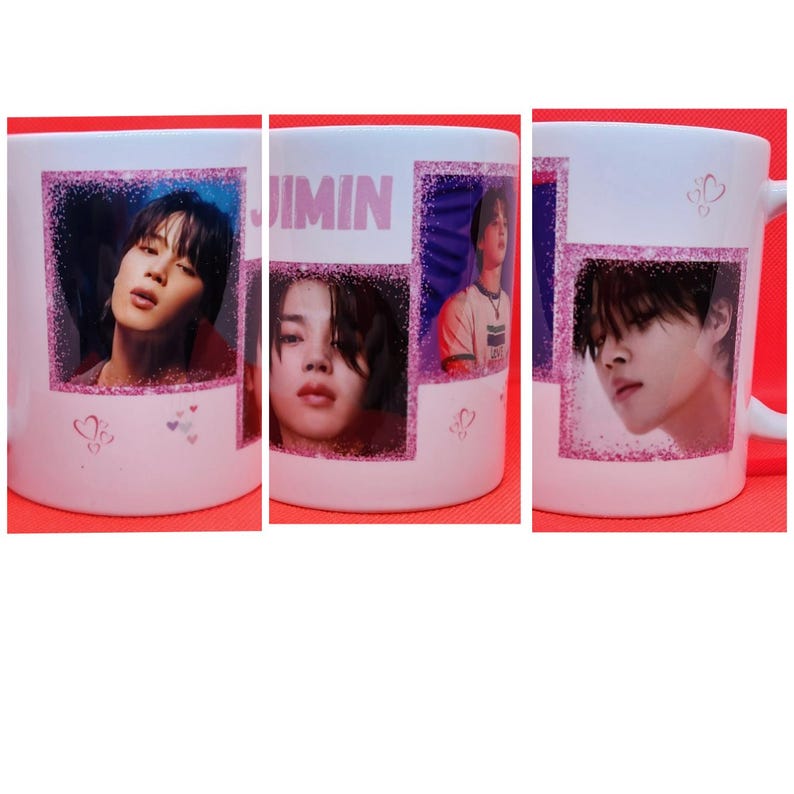 May include: White ceramic mug with a pink glitter design. The mug features four images of a person with the word "JIMIN" printed on the mug.