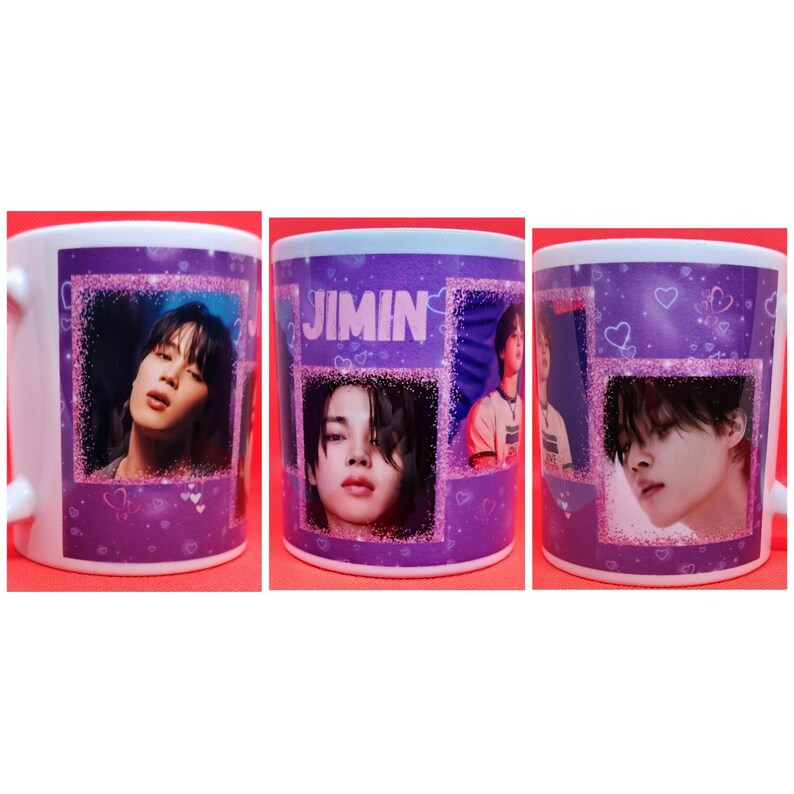 May include: A white ceramic mug with a purple background and a glittery design. The mug features images of a young man with dark hair and the word "JIMIN" in pink letters.