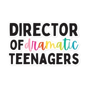 May include: A white sticker with the text "DIRECTOR OF dramatic TEENAGERS". The word "dramatic" is written in a rainbow gradient of pink, orange, yellow, and teal. The other words are in bold black font.