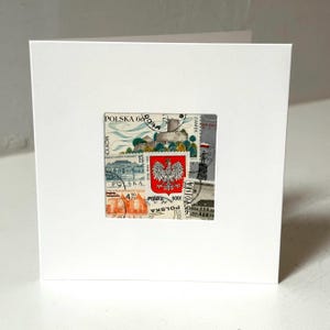May include: A white card with a collage of vintage Polish postage stamps featuring the Polish coat of arms, a castle, and other imagery. The stamps are arranged in a square shape and have the text "POLSKA" and "ZAMEK" on them.