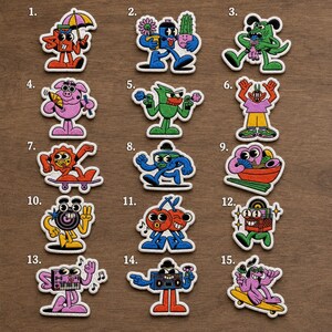 May include: A collection of fifteen embroidered patches featuring cartoon characters in various colors and poses. The designs include figures with umbrellas, cacti, skateboards, musical instruments, food items, and boomboxes, all with bold outlines.