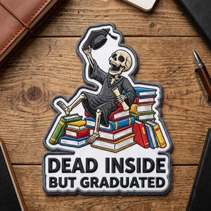 May include: Embroidered patch featuring a skeleton in a graduation gown and cap, sitting atop a stack of books. The patch reads "DEAD INSIDE BUT GRADUATED" in white text with a gray border. The design is colorful and detailed.