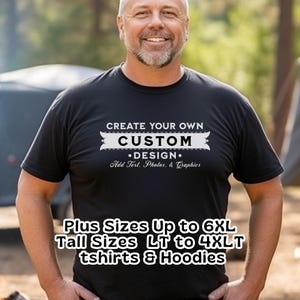 May include: Black t-shirt with white text that reads "CREATE YOUR OWN CUSTOM DESIGN. Add Text, Photos, & Graphics." Additional text at the bottom states "Plus Sizes Up to 6XL Tall Sizes LT to 4XLT tshirts & Hoodies."