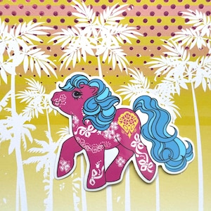 May include: A pink cartoon pony sticker with blue hair and a long, flowing tail. The pony is decorated with white floral and bow designs. The background features white palm trees and a yellow and pink gradient.