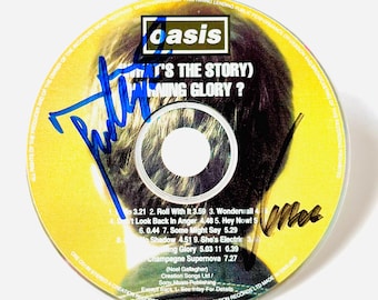 CD con el álbum firmado original de Noel Gallagher y Liam Gallagher + Certificado de Autenticidad (COA)