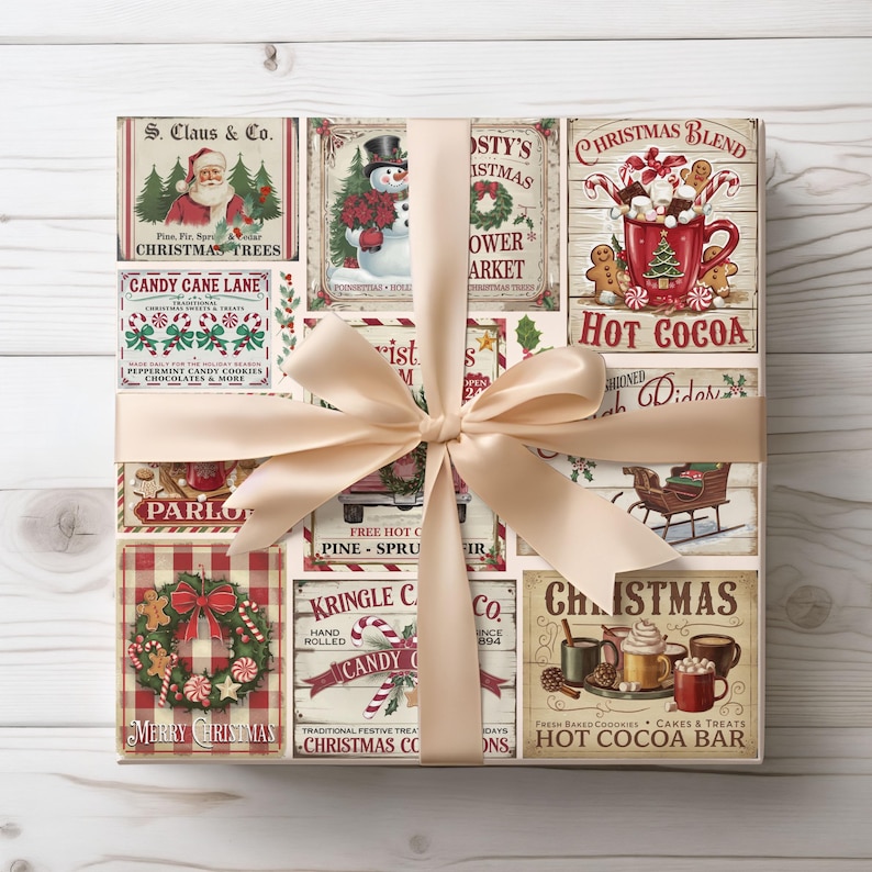 May include: A wrapped gift box with a cream-colored bow. The wrapping paper features vintage Christmas-themed illustrations, including Santa Claus, snowmen, and hot cocoa. Text includes "Merry Christmas" and "Hot Cocoa Bar."