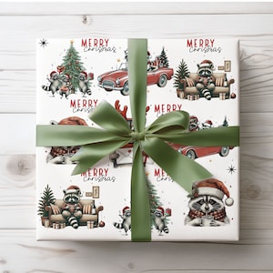 May include: White wrapping paper with a repeating pattern of raccoons in Santa hats, Christmas trees, and red convertibles. The words "Merry Christmas" are printed throughout the design. A green ribbon is tied around the wrapped gift.