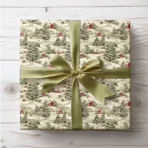 May include: A green and white gift box with a winter scene pattern. The box is tied with a green satin ribbon and bow.